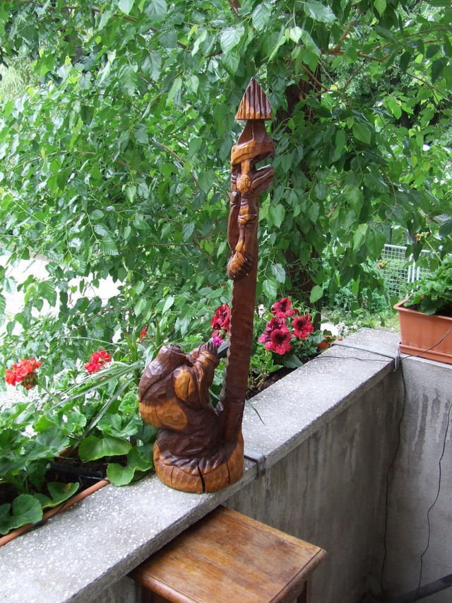Statuie infatisand o baba rugandu-se la o troita Statuie infatisand o baba rugandu-se la o troita